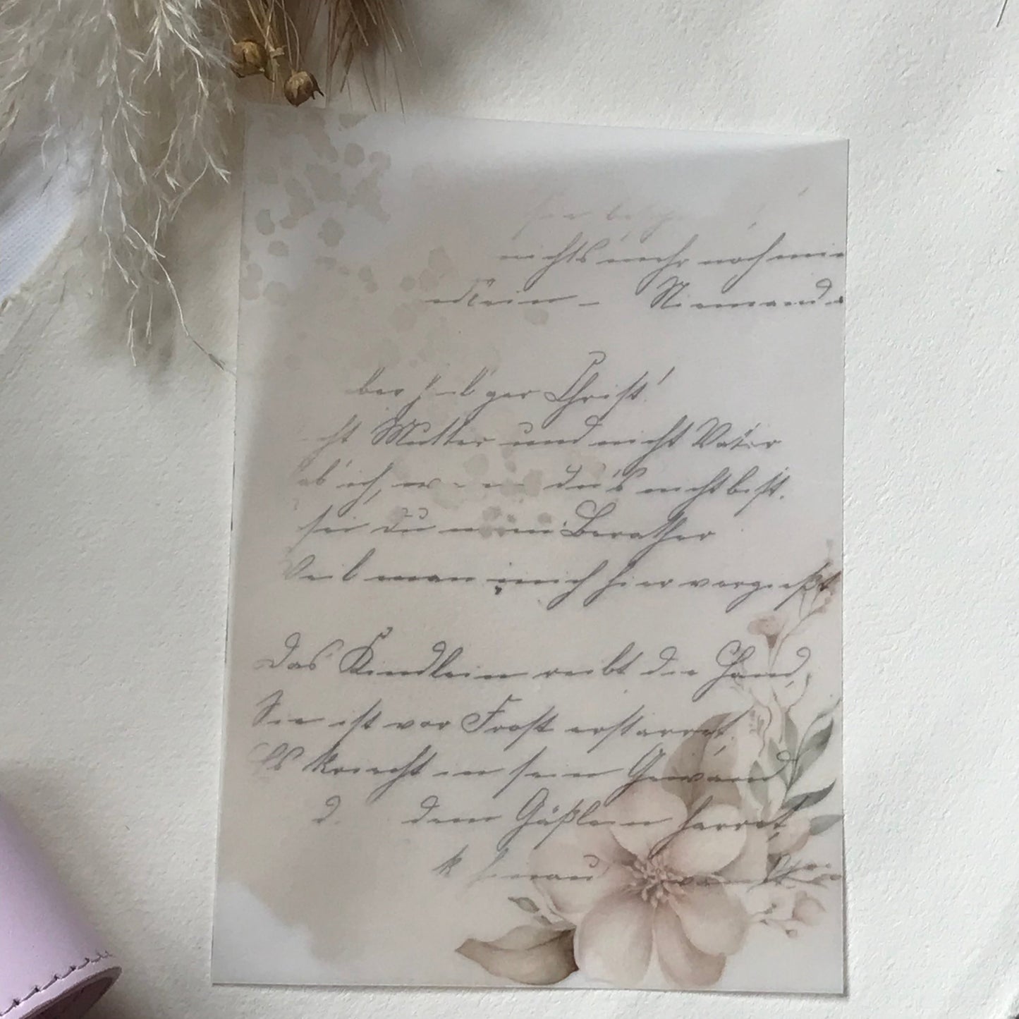 Script style vellum with a floral design