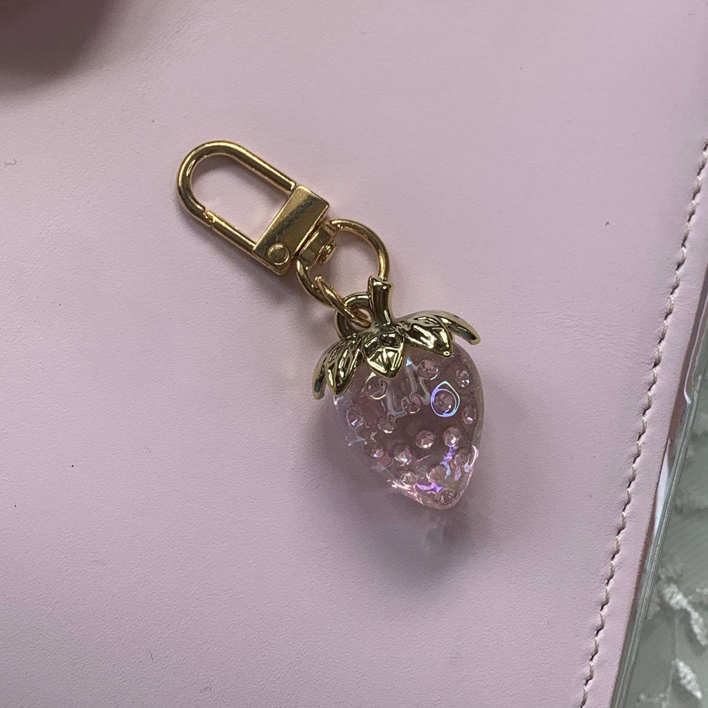 Gold keychain and pink strawberry-shaped charm