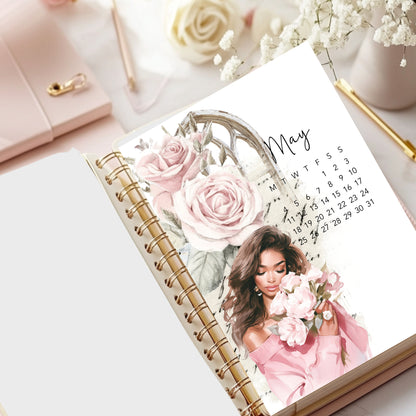 May 2026Calendar with floral design and a woman holding flowers on a desk with a pink handbag and white roses.